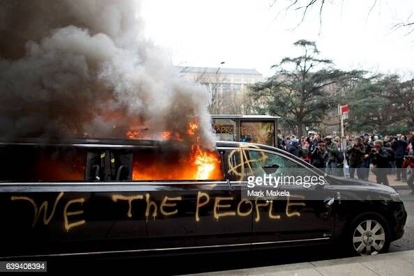 limousine-is-set-aflame-with-we-the-people-spray-painted-on-the-side-picture-id639408394.jpg